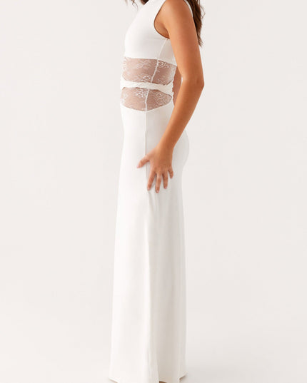 Side profile of a women's white sleeveless maxi dress, showcasing the crew neck and intricate lace panel design.