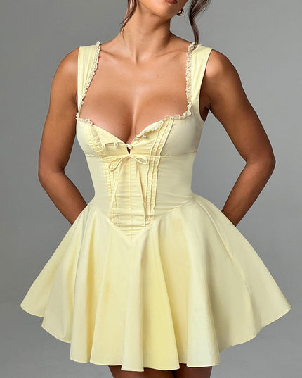 Front detail of the lemon yellow pintuck mini dress, showing the sweetheart neckline and structured bodice.