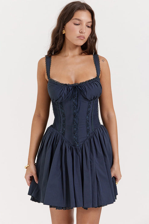 Close-up front view of navy blue corset mini dress with lace-up detail, shirred bodice, and delicate lace trim.