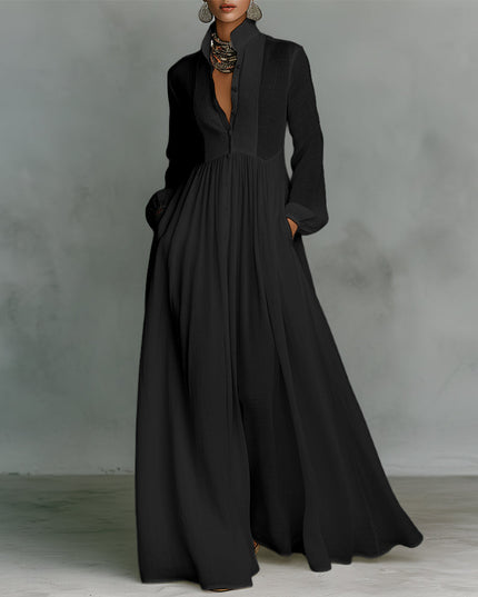 Black button-down stand collar jumpsuit with elegant lantern sleeves and flowing wide-leg pants, for evening wear.