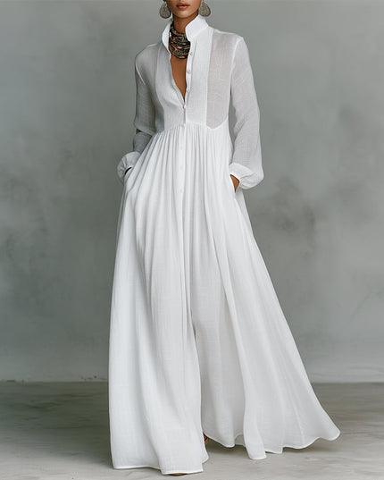 White button-down stand collar jumpsuit with lantern sleeves and wide legs, featuring gathered waist and pockets.