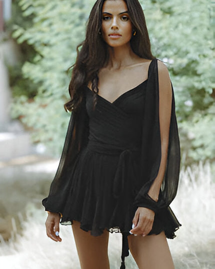 Black V-neck mini dress with long open sleeves, a tie waist, and a flowing, ruffled skirt.