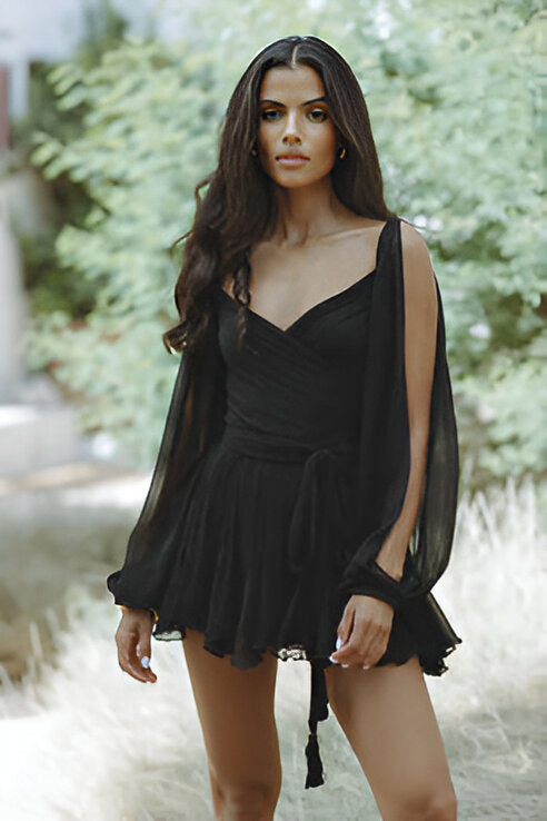 Black V-neck mini dress with long open sleeves, a tie waist, and a flowing, ruffled skirt.