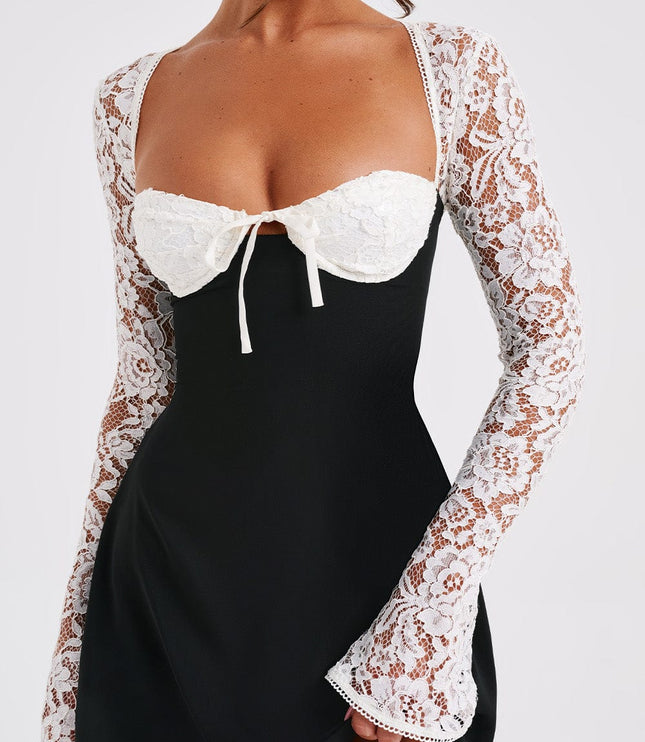 Close-up of the black and white lace long sleeve mini dress, focusing on the white lace bust and tie detail.