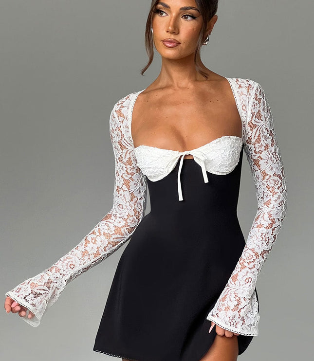 Women's black and white lace mini dress with long bell sleeves, captured in a dynamic pose.