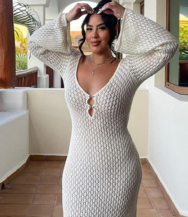 Front view of a white long sleeve crochet maxi dress with a V-neck and two small buttons, worn on a balcony.