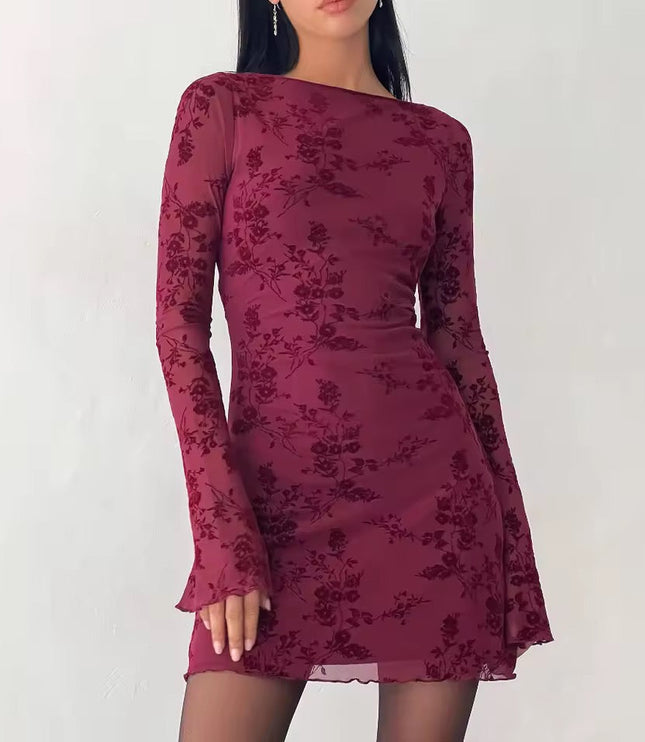 Front view of a maroon floral print long sleeve mini dress, featuring a boat neck and sheer bell sleeves with a lettuce hem.
