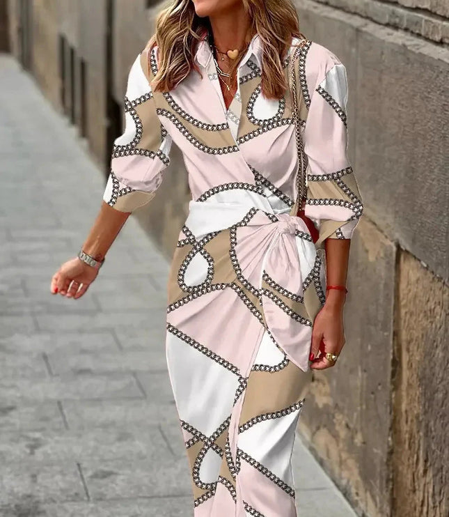 Women's long sleeve V-neck midi dress featuring a light pink, white, and beige chain-link pattern, tied at the waist.
