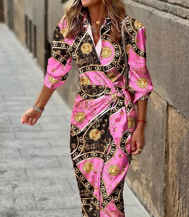 Pink and black women's long sleeve V-neck midi dress with an intricate gold baroque and chain pattern, tied at the side.