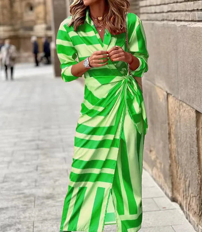 Women's long sleeve V-neck midi dress with a vibrant green and light green striped pattern, tied at the waist.