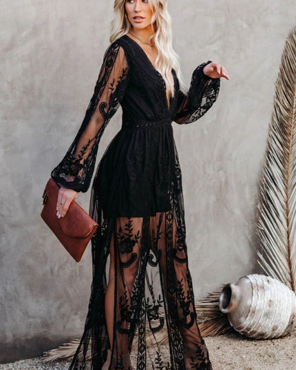 Three-quarter view of a women's black lace long sleeve V-neck maxi dress, showcasing the full length and sheer fabric.