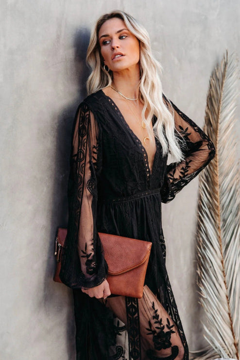 Close-up of a women's black lace long sleeve V-neck maxi dress, focusing on the lace detail and neckline.