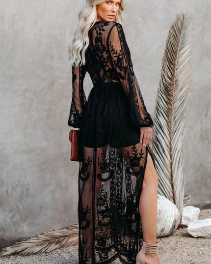 Back view of a women's black lace long sleeve V-neck maxi dress, highlighting the sheer skirt and intricate lace.