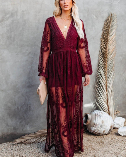 Full-length burgundy lace long sleeve V-neck maxi dress with a sheer overlay and intricate floral embroidery.