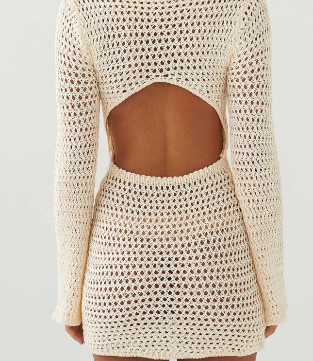 Back view of the cream long sleeve crochet mini dress, clearly showing the open back cut-out design.