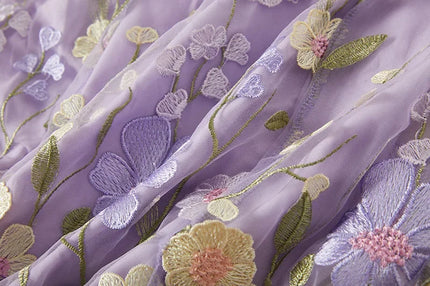 Fabric detail of the women's lavender floral embroidered sheer maxi dress, showcasing the layered floral appliques.