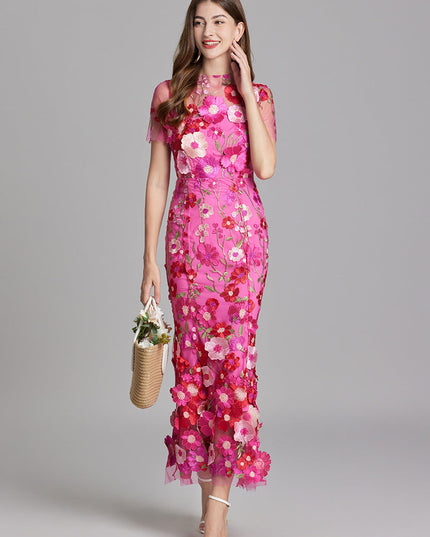 Elegant women's vibrant pink floral embroidered sheer maxi prom dress, showcasing the intricate flower details and sheer fabric.
