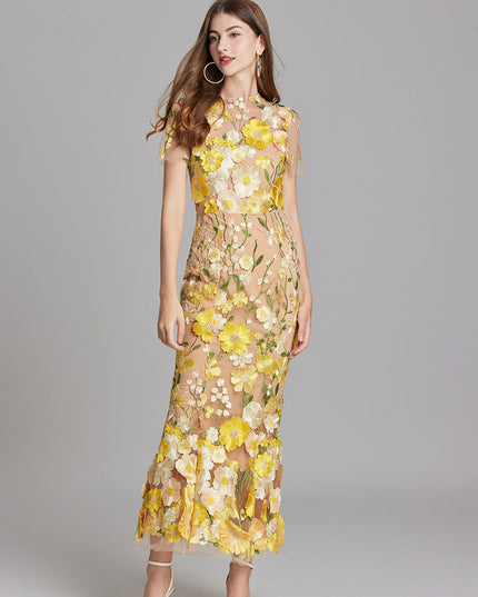 Front view of women's yellow and white floral embroidered sheer maxi prom dress, short sleeves, in a gentle pose.