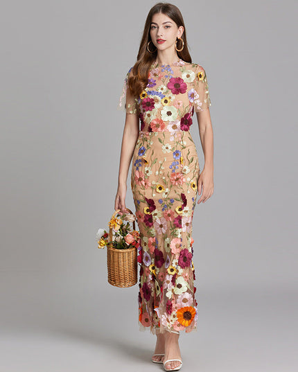 Full-length women's multi-color floral embroidered sheer maxi prom dress, short sleeves, holding a flower basket.