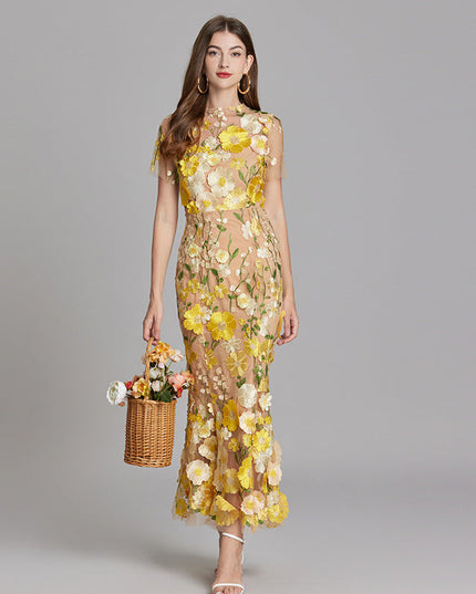 Full-length women's floral embroidered sheer maxi prom dress in yellow and white, short sleeves, holding a basket.