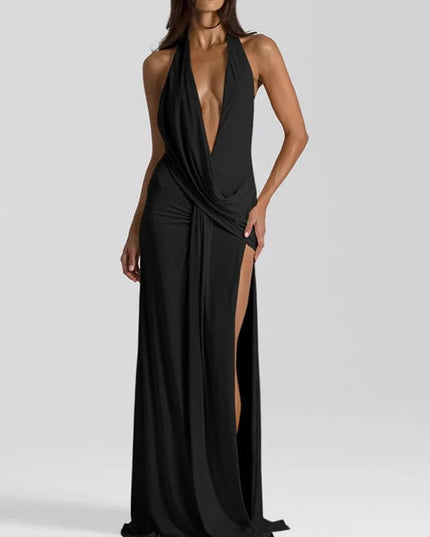 Black halter v-neck backless maxi dress with deep plunging neckline and ruched side slit detail.