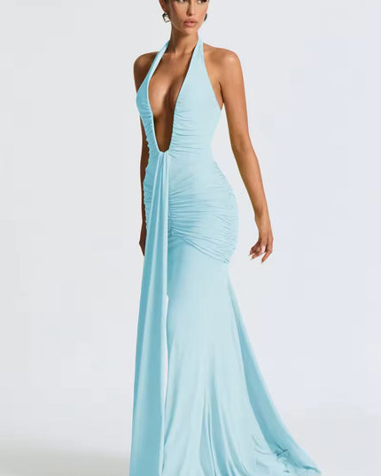 Side profile of a women's light blue deep V halter ruched mermaid maxi dress, showcasing the silhouette and ruching.