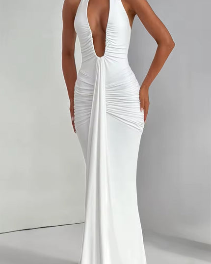 Front detail of a white deep V halter ruched mermaid maxi dress, emphasizing the deep neckline and gathered fabric.