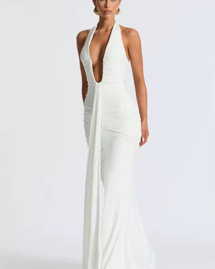 Angled view of a white deep V halter ruched mermaid maxi dress, showing the elegant drape and floor-length design.