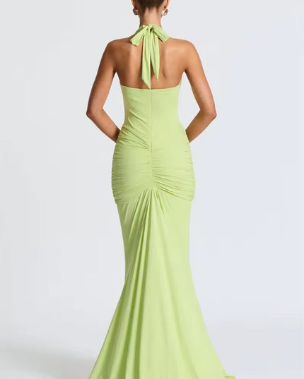 Back view of a light green deep V halter ruched mermaid maxi dress, showing the tied halter neck and ruched back detailing.
