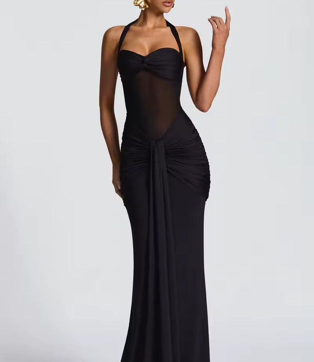 Full view of a women's black halter neck ruched mesh maxi dress, with sheer midriff and elegant draping.