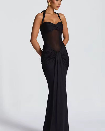 Side view of a women's black halter neck ruched mesh maxi dress, showcasing the fitted silhouette.