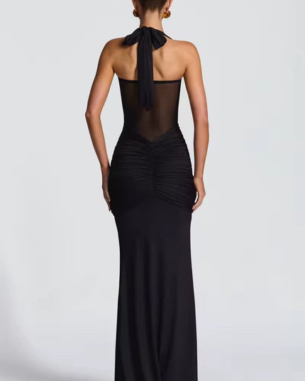 Back view of a women's black halter neck maxi dress with a tie-neck and ruched details on the back.