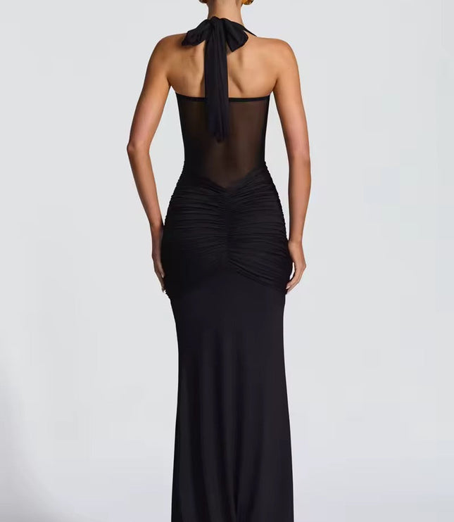 Back view of a women's black halter neck maxi dress with a tie-neck and ruched details on the back.