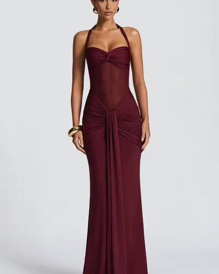 Elegant women's burgundy prom dress with a halter neck, sheer mesh midriff, and intricate ruching detail on the skirt, for formal events.