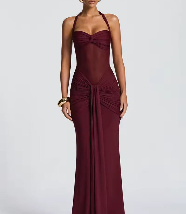 Elegant women's burgundy prom dress with a halter neck, sheer mesh midriff, and intricate ruching detail on the skirt, for formal events.