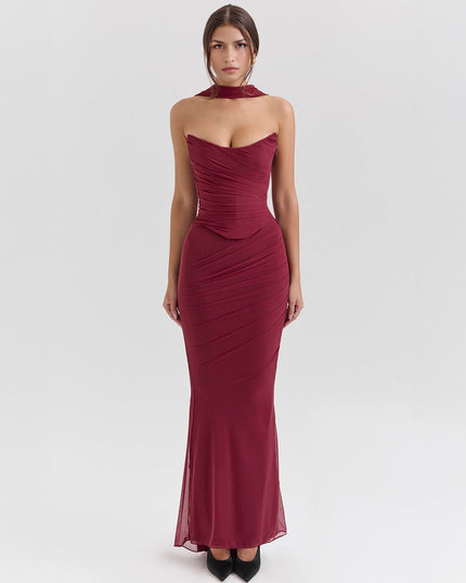 Front view of a deep red strapless mesh ruched maxi dress with a choker detail
