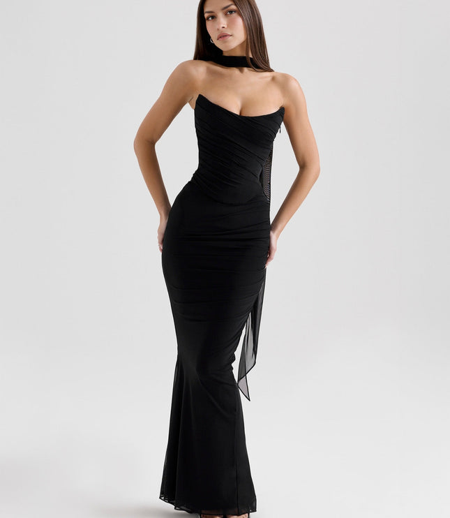 Elegant black strapless mesh ruched maxi dress with flowing sheer fabric detail, styled for a formal event.