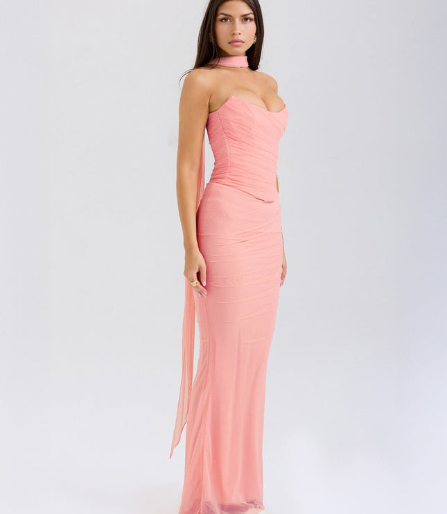 Side profile of the pink strapless mesh ruched maxi dress, showing the flowing skirt and fitted bodice.