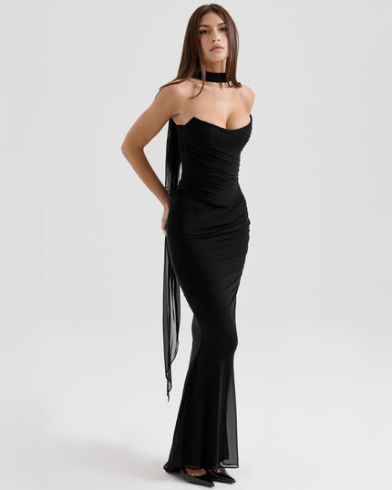 Three-quarter view of a black strapless mesh ruched maxi dress, highlighting the elegant silhouette and draped fabric.