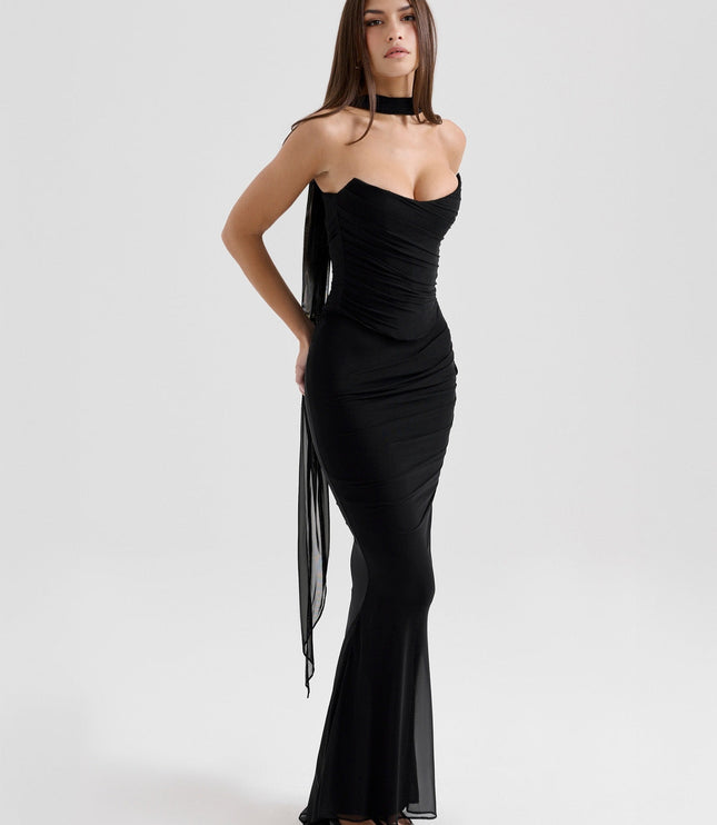 Three-quarter view of a black strapless mesh ruched maxi dress, highlighting the elegant silhouette and draped fabric.
