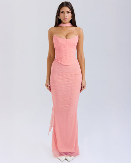 Full-length view of a women's strapless pink mesh ruched maxi dress with a choker detail, for special occasions.