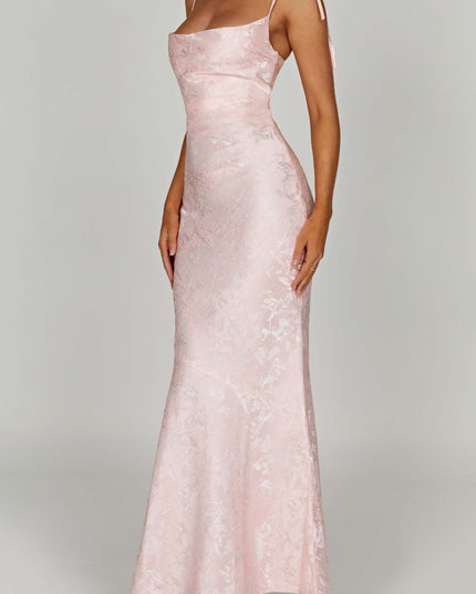 Side angle of the women's pink floral maxi dress with tie straps, highlighting the fitted bodice and flowing skirt.