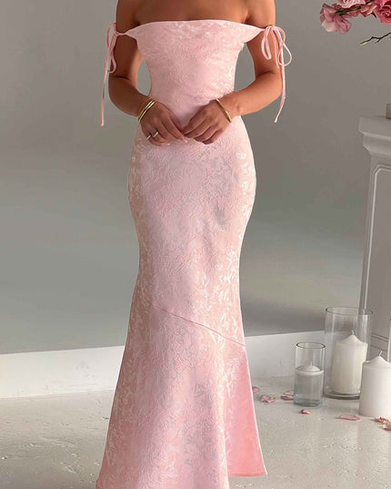 Women's off-shoulder pink floral maxi dress, showcasing the tie-strap detail and elegant, flowing design.