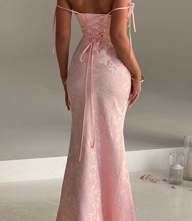 Rear view of women's pink floral off-shoulder maxi dress, highlighting the lace-up back and elegant drape.
