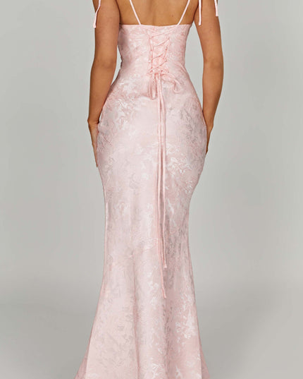 Back view of the pink floral maxi dress on a plain background, emphasizing the lace-up back and long skirt.