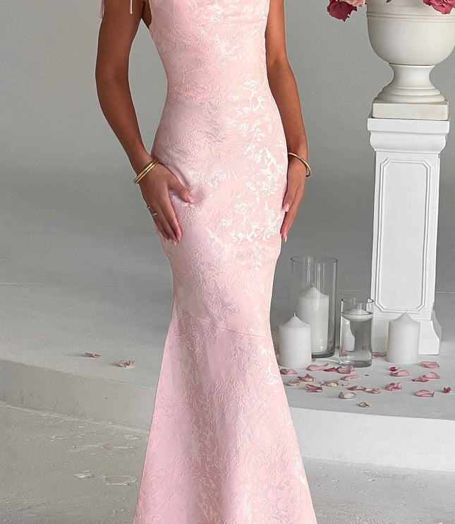 Front view of a women's pink floral maxi dress with delicate tie straps and a fitted silhouette, for special occasions.