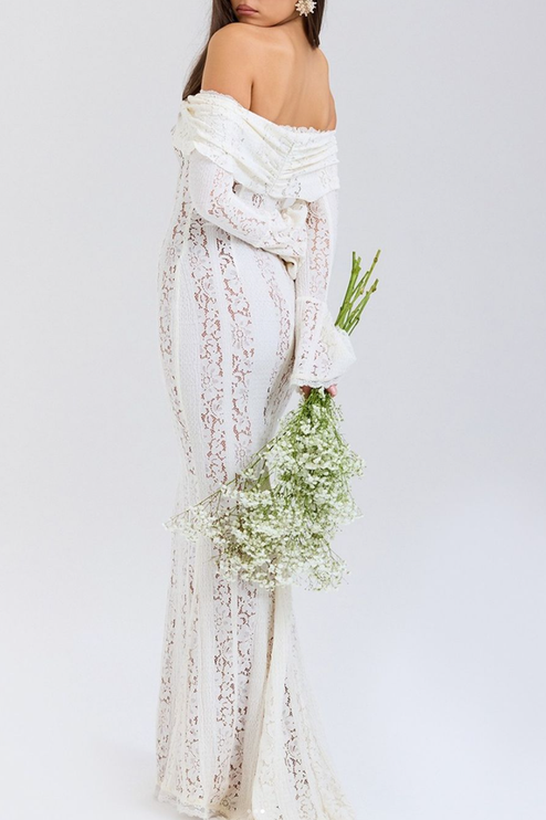 Back view of the white floral lace off-shoulder long sleeve maxi dress, with a subtle train and bell sleeves.
