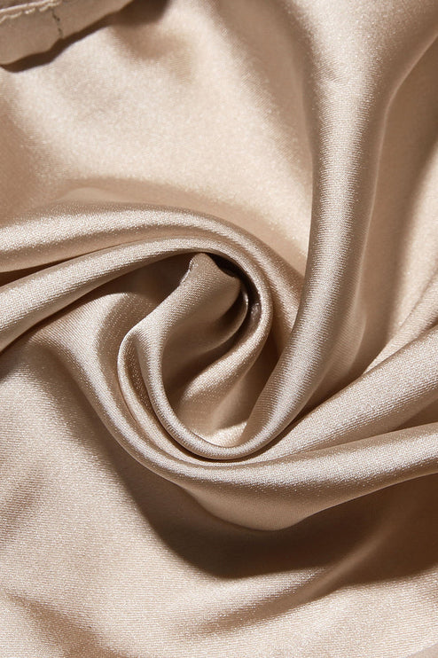 Close-up texture of the champagne-colored satin lining fabric, showing its smooth and shiny finish.