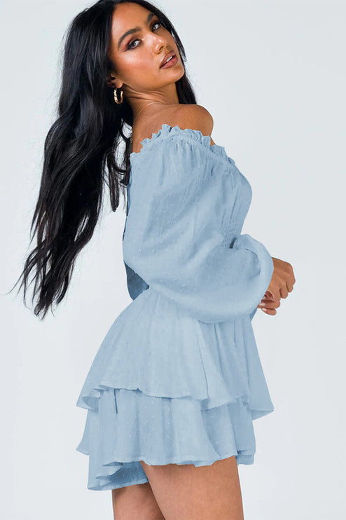 Side profile of light blue off-shoulder mini dress, showing tiered skirt and flowing sleeves