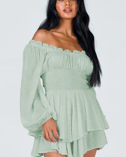 Close-up of a women's light green off-shoulder mini dress with ruched bodice and long balloon sleeves.